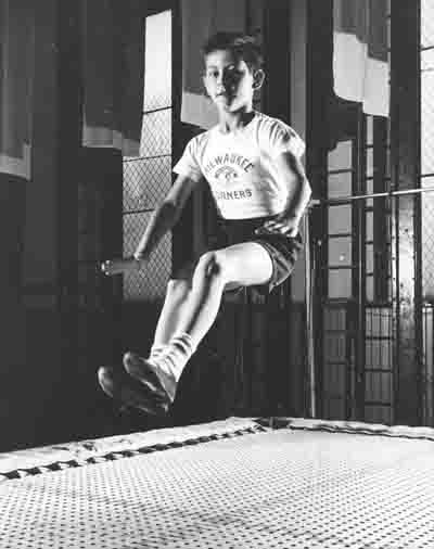 Milwaukee Turner boy bouncing on trampolilne