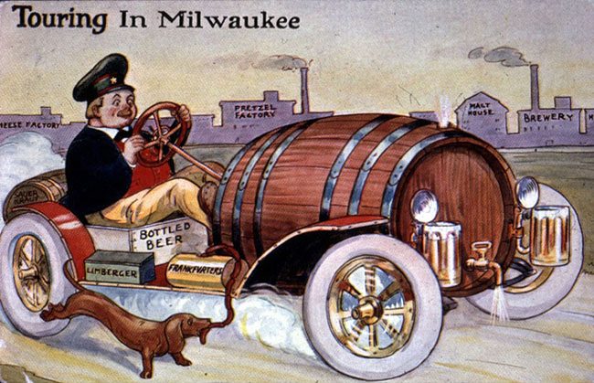 "Touring Wisconsin" postcard, showing a Dutchman driving a "beer vehicle," with a tap barrel engine, beer stein lights, and boxes for limberger and frankfurters