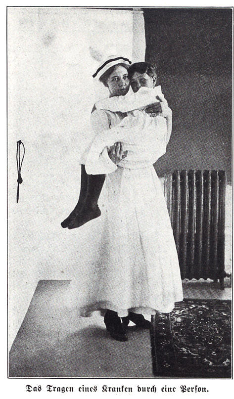 A nurse carrying a child