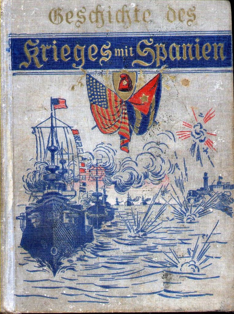 Cover of Geschichte des Krieg mit Spanien, showing a fleet of warships under steam, passing a fortress on a rocky shore. Explosions occur in the water and in the air.