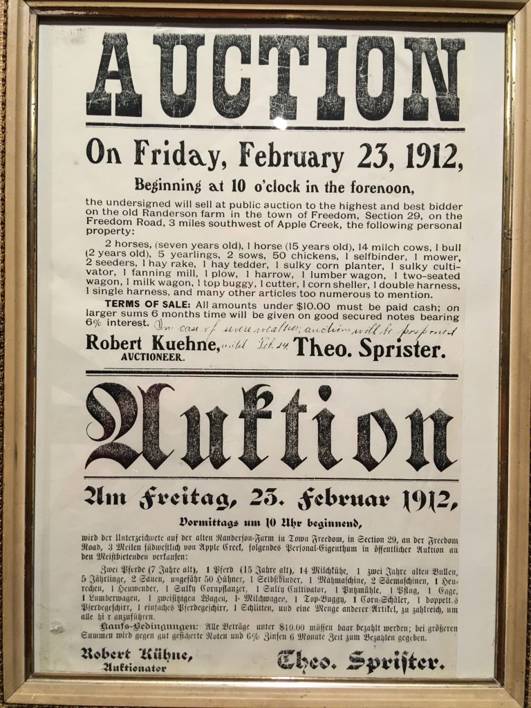 A 1912 auction poster in both English and German.