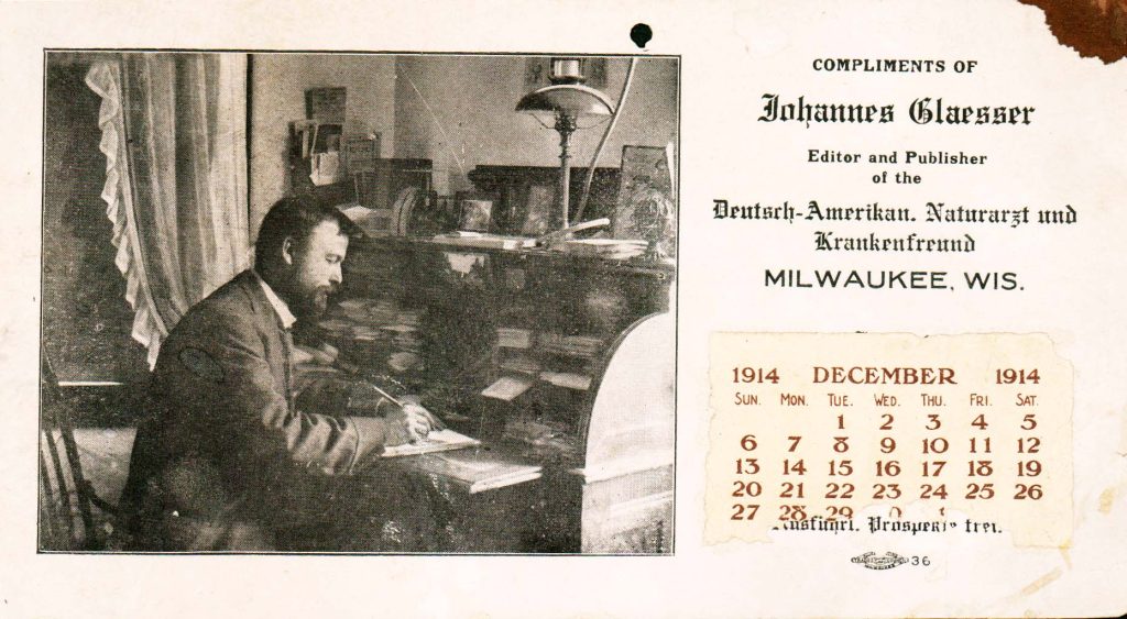 An image of Johannes Glaesser writing at a desk.